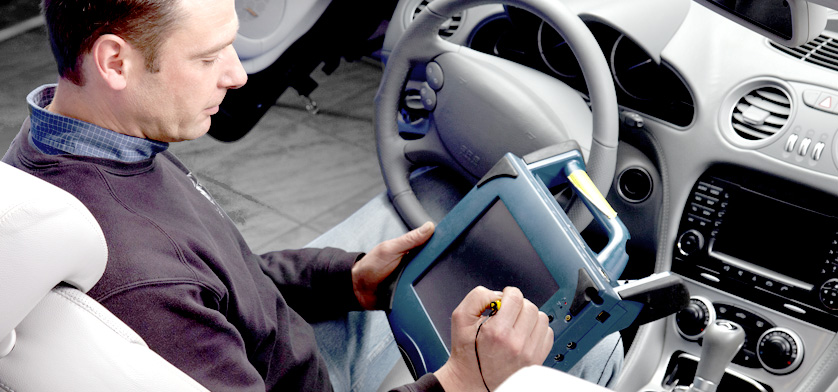 Industries - Diagnostic a man using a car diagnostic device