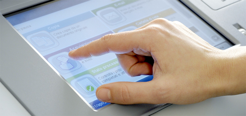 Industries - Printing presses a hand touching a touch screen