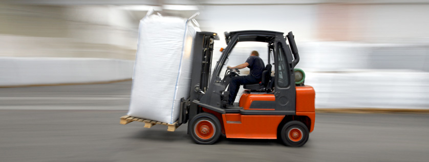 Industries - Forklift terminals a man driving a forklift carrying a large bag