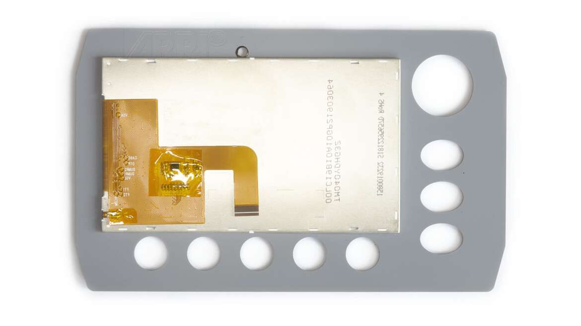 Optical Bonding - Optical Bonding: um dispositivo retangular cinza com uma placa de ouro e prata